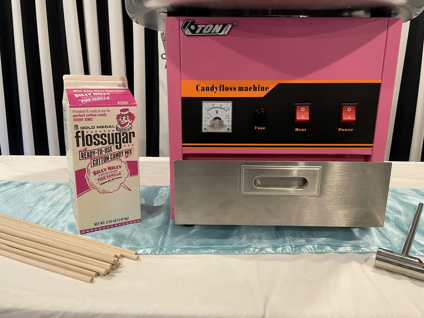 The candy-floss machine controls, drawer, sugar, sticks and scoop.