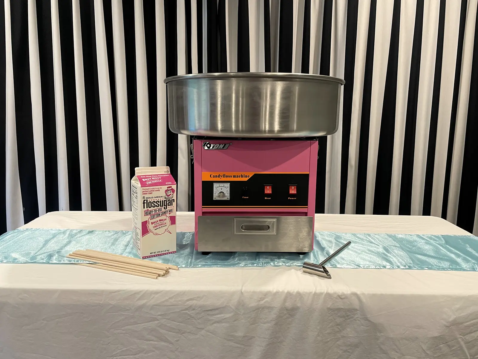 Playday’s pink candy-floss machine with floss sugar, paper sticks and metal scoop.