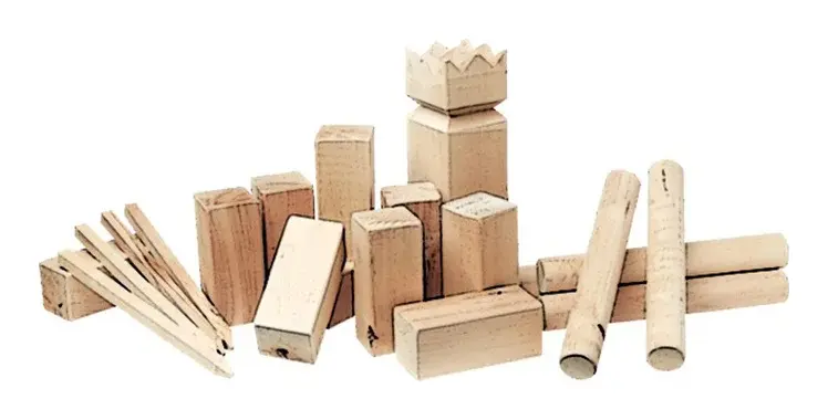 A Kubb set of chunky wooden blocks, throwing batons and a crowned king block.